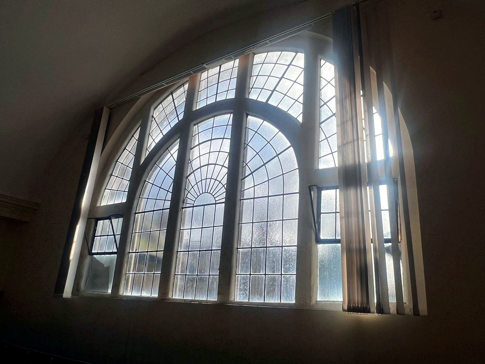 Secondary glazing fitted to a tall arched feature window