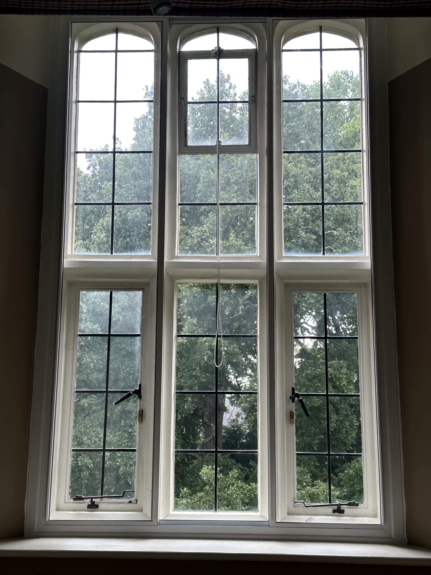A pair of arched leaded secondary glazing units on a heritage property