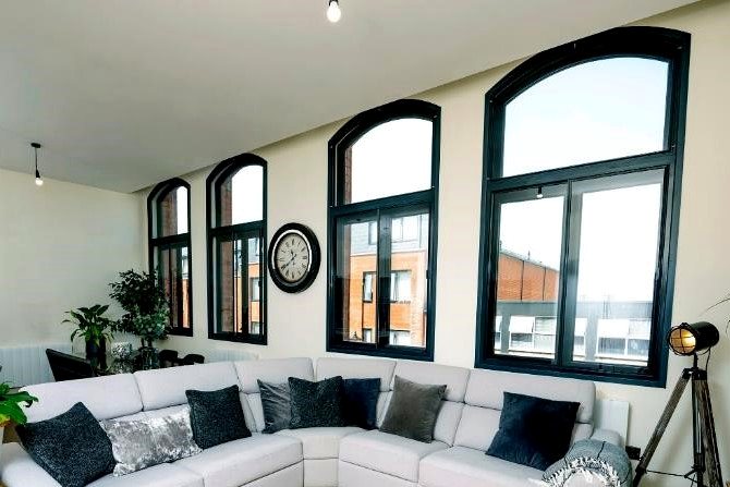Three arched secondary glazing units in a living room