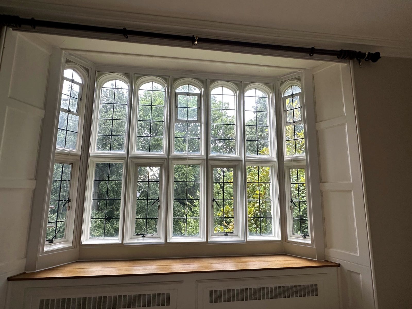 A run of arched secondary glazing in a bay