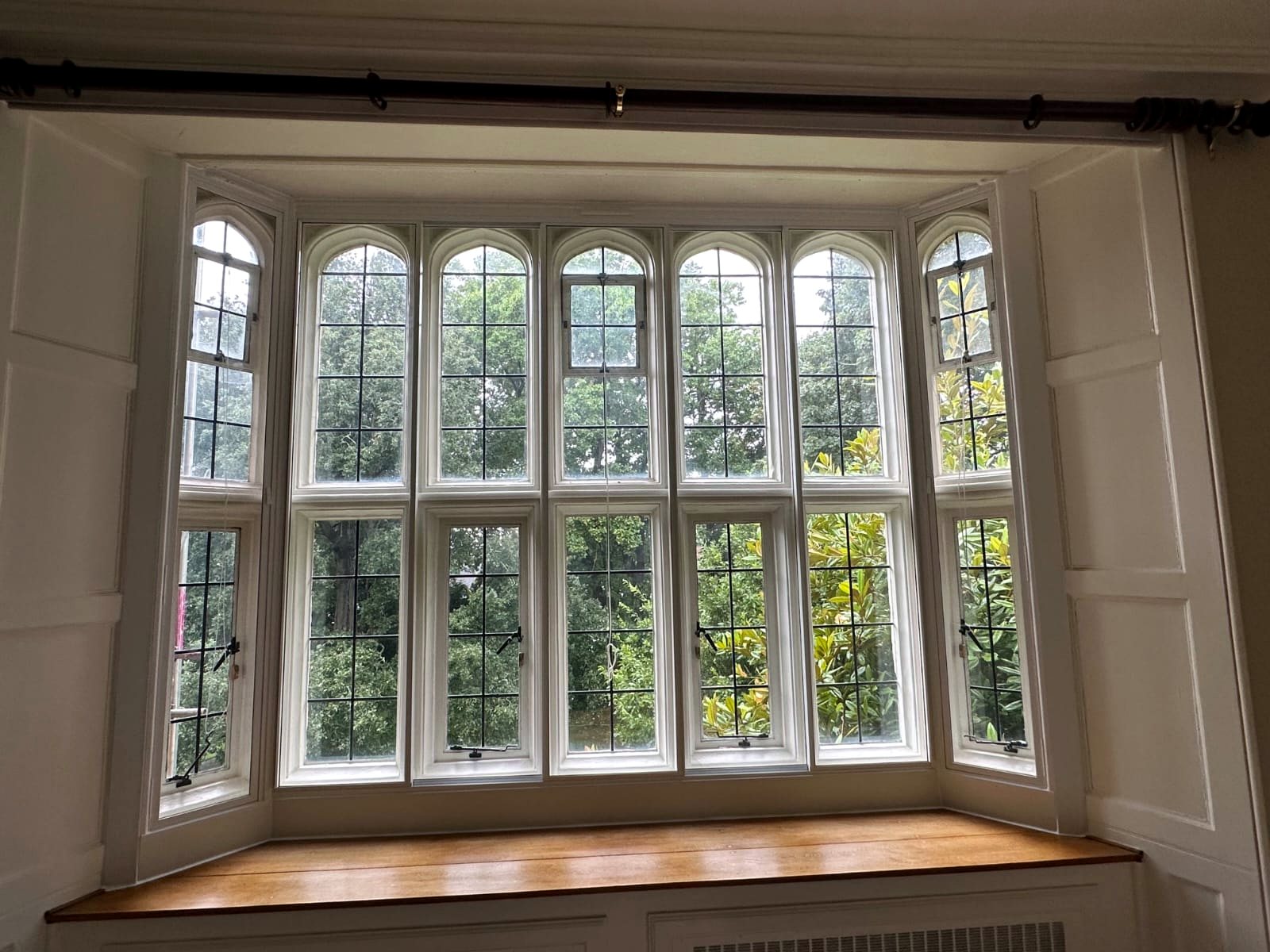 Arched secondary glazing bay above a window seat