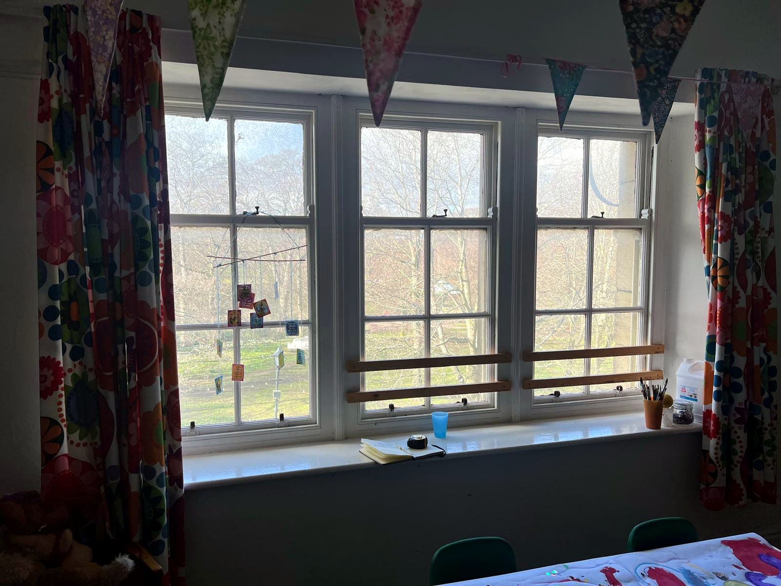 Secondary glazing behind a leaded bay window in a curtained reception room