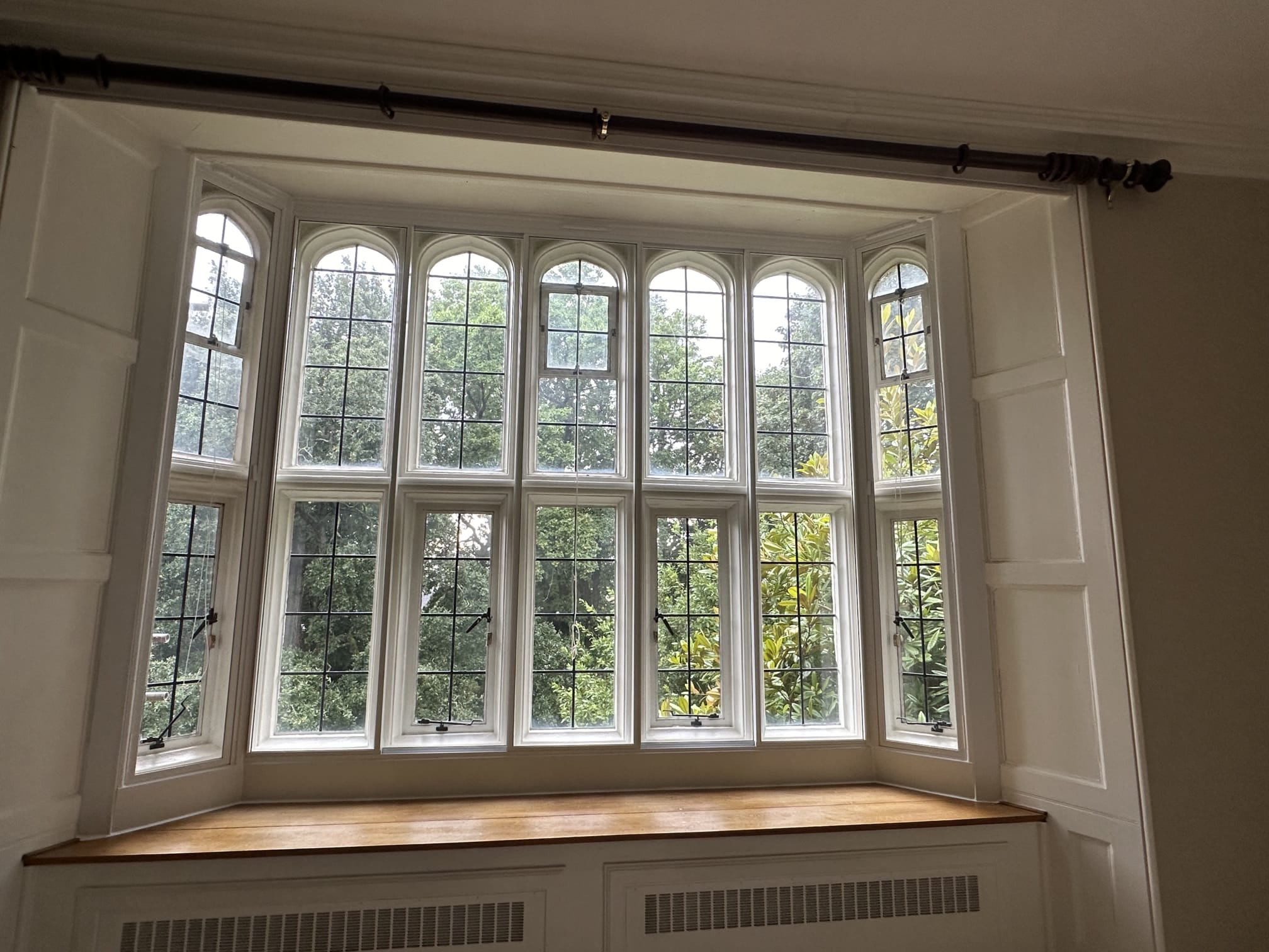 Large bay window with five arched secondary glazed panels in period property — full installation