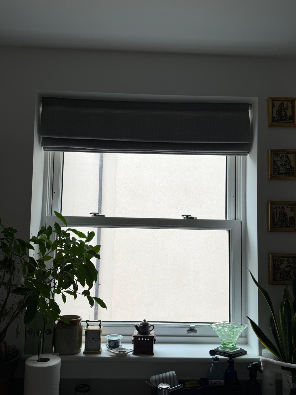 Slim secondary glazing on vertical sash window showing discreet slim aluminium profile in bedroom setting