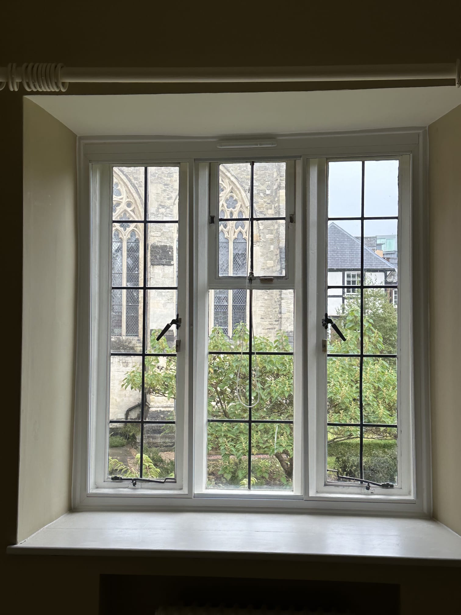 Large three-panel arched and bottom-sash secondary glazing — listed property full wall window installation