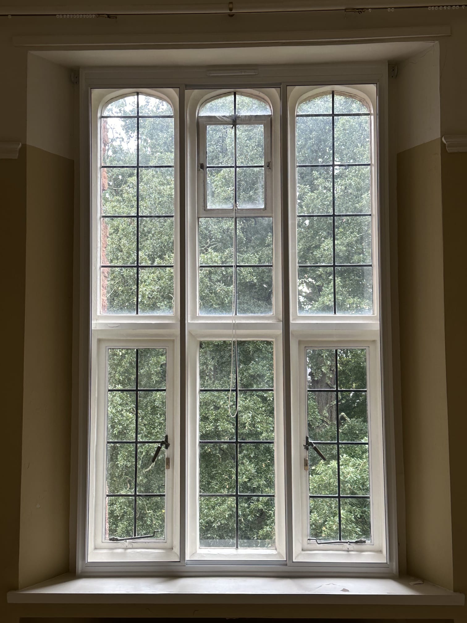 Heritage arched secondary glazing — tall narrow single panel with Gothic arch on period property