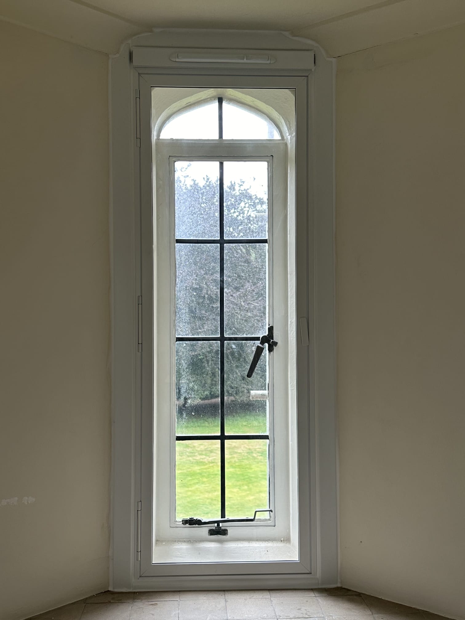 Single slimline double-panel white secondary glazing on double casement window — heritage property