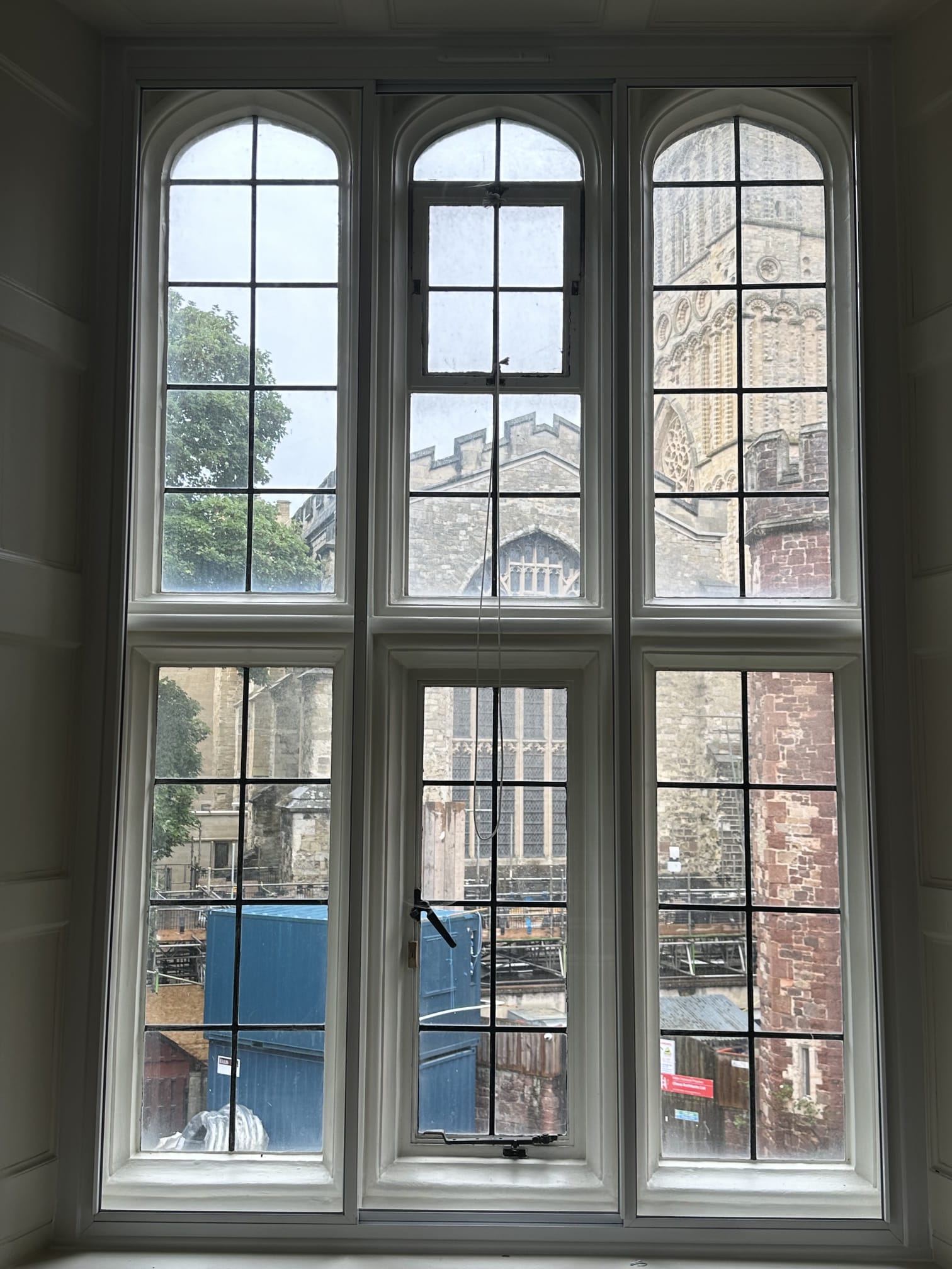 Three-panel secondary glazing on large arched windows in heritage property