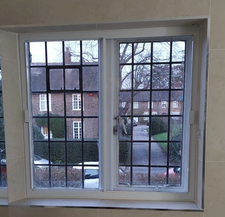 Horizontal sliding secondary glazing installed on double casement window in residential property
